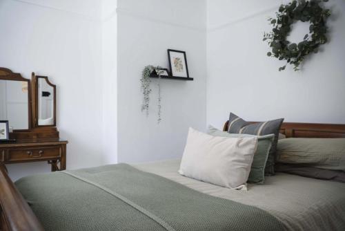 a bedroom with a bed and a mirror on the wall at Taf Fechan - 3 Bedroom House - Pontsticill in Merthyr Tydfil