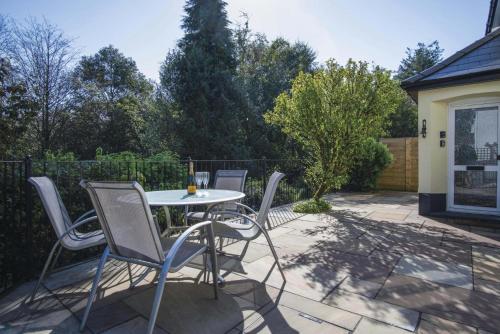a patio with a table and chairs on a patio at Taf Fechan - 3 Bedroom House - Pontsticill in Merthyr Tydfil