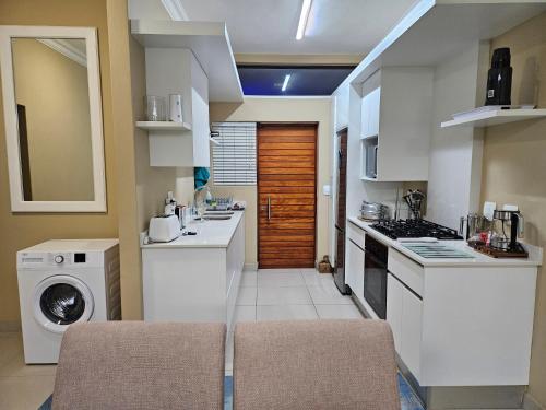 a kitchen with a washing machine and a washer at The Gull in Sedgefield