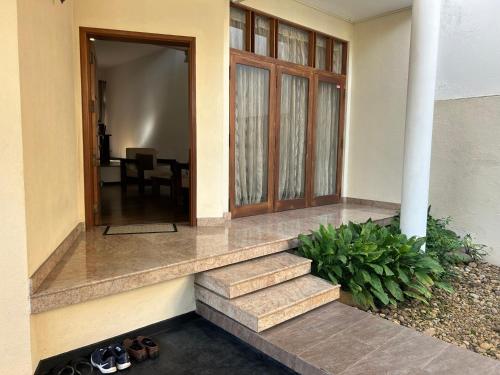 a house with a staircase leading to a door at Occazia Residence in Colombo