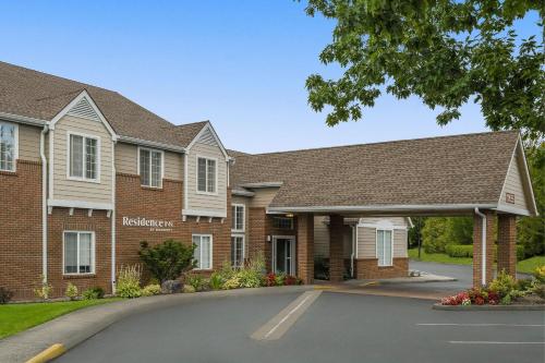 a large brick building with a parking lot at Residence Inn Portland Hillsboro in Hillsboro