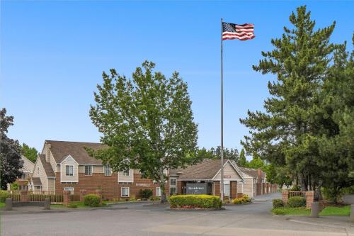 an american flag flying in front of a house at Residence Inn Portland Hillsboro in Hillsboro