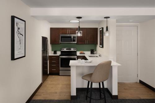 a kitchen with a white counter and a chair in it at Residence Inn Portland Hillsboro in Hillsboro