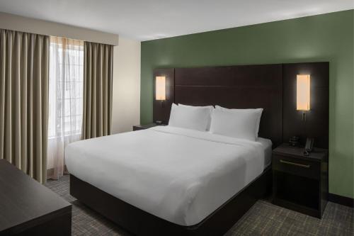 a large white bed in a hotel room at Residence Inn Portland Hillsboro in Hillsboro