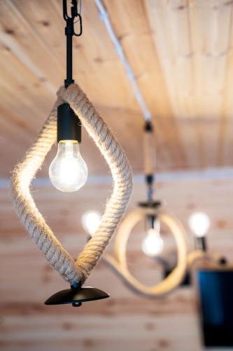 a couple of ropes hanging from a ceiling with a light at Cottage Caucasus in Ushguli