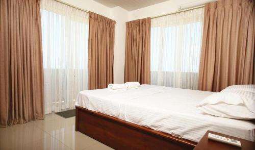 Ένα ή περισσότερα κρεβάτια σε δωμάτιο στο A1 Apartments at Ocean Breeze Residency