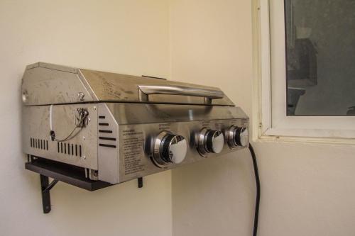 a toaster hanging on a wall next to a window at Creuza de Mä in Playa del Carmen