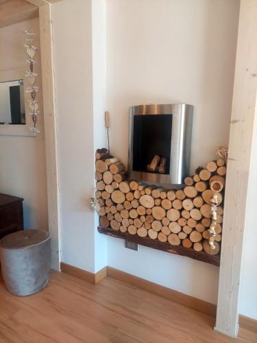 a fire place in a room with a pile of logs at Loft Tirano centro storico - open space Adele in Tirano