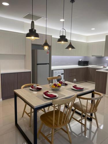 a kitchen with a table and chairs in a kitchen at Suasana Suites Johor Bahru City Centre in Johor Bahru