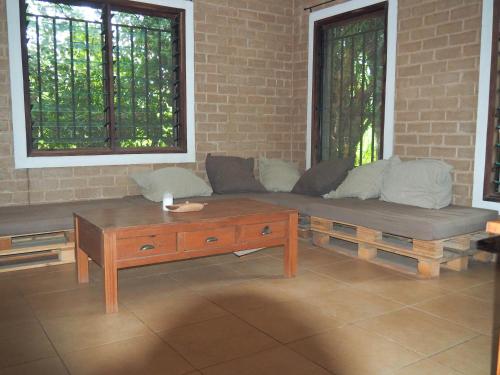 a living room with a couch and a coffee table at MyFarm - Nema Kunku - An Educational Centre in Ker Dobaly