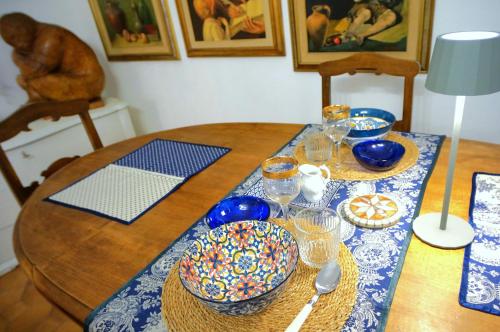 a dining room table with a blue and white table cloth at Appartamento Arte in Imperia