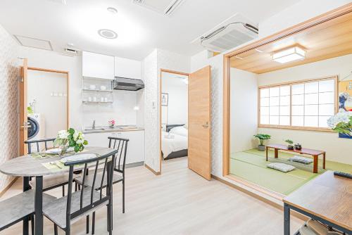 a room with a dining table and a room with a bedroom at Bright Modern Airbnb in Tokyo's Northern District in Tokyo