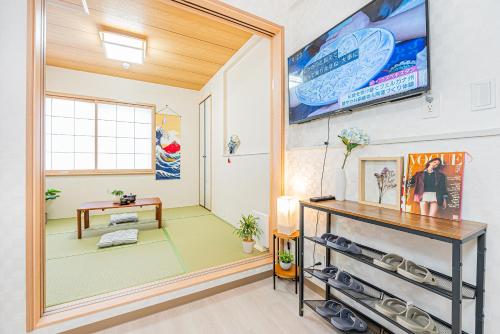 a room with a large mirror and a tv on the wall at Bright Modern Airbnb in Tokyo's Northern District in Tokyo