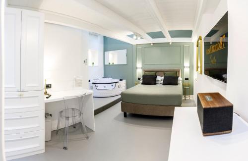 a bedroom with a bed and a sink and a desk at CorsoVittorio87Suite in Cagliari