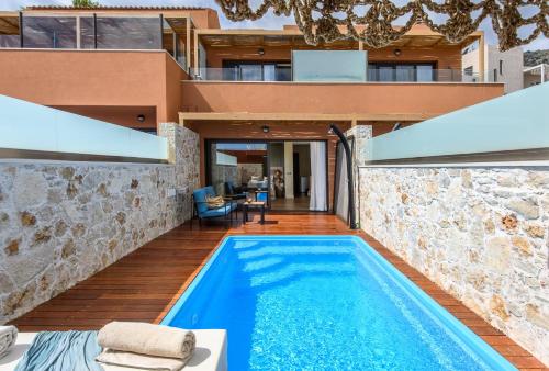 an external view of a house with a swimming pool at Esperides Resort Crete, The Authentic Experience in Hersonissos