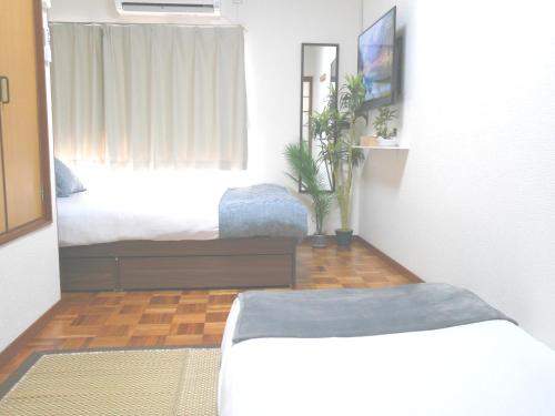 Postel nebo postele na pokoji v ubytování 大阪西九条stay5