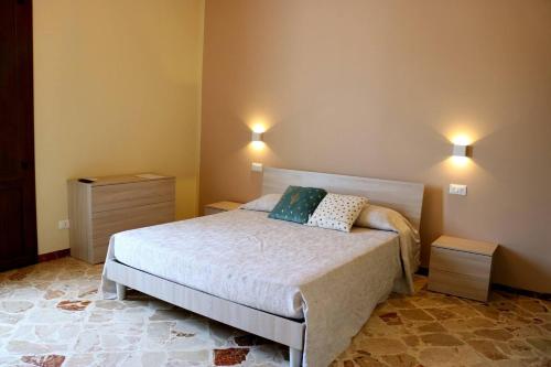 a bedroom with a bed with two pillows on it at Casa Rosina in San Vito lo Capo