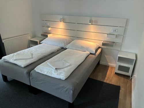 a bed in a room with lights on the wall at Benjamin Apartman in Budapest