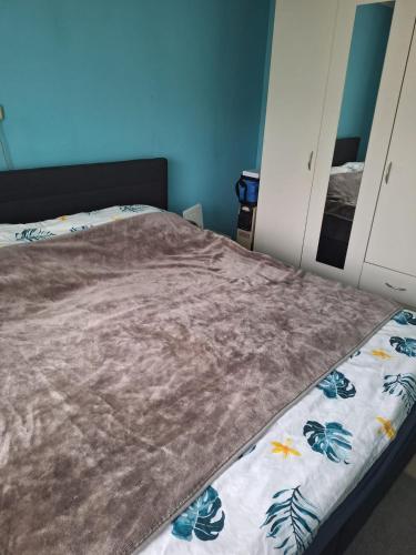 a bedroom with a bed with a blanket on it at Apartments Rainbow in Pörtschach am Wörthersee