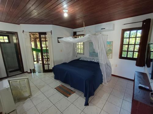 a bedroom with a bed with a canopy at MangoBrazil in Imbassai