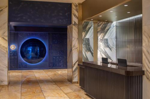 an office lobby with a desk and a blue wall at Le Meridien New York, Central Park in New York