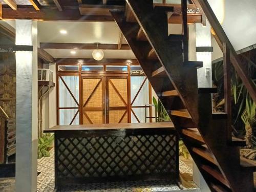 a staircase leading up to a room with a window at Dahun Villas Siargao in General Luna