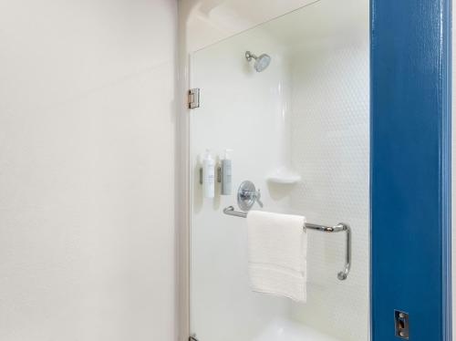 a bathroom with a shower with a towel at Spark by Hilton Augusta in Augusta