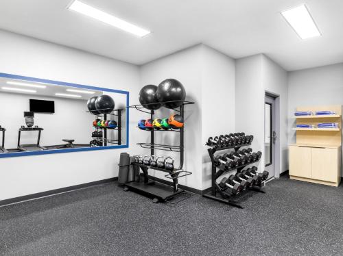 a fitness room with two racks of equipment at Spark by Hilton Augusta in Augusta