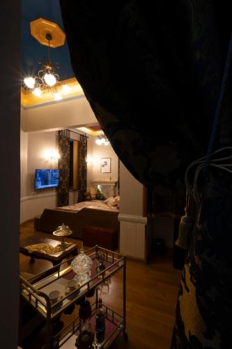 a living room with a bed and a glass table at Medουσία Wellness Hotel & Spa in Chalkida
