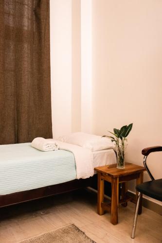 two beds in a room with a table at Akim Homestay in Kohīma