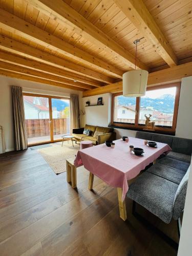 a living room with a table and a couch at Chic lodge-apartments in Ehrwald