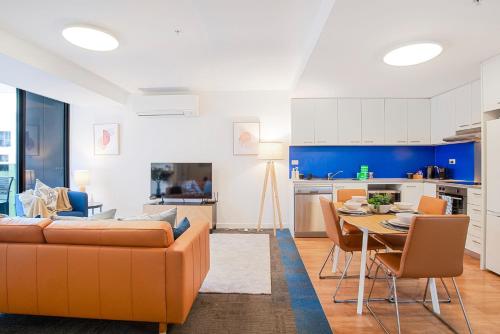 a living room and kitchen with a couch and a table at The Waymouth Executive I Workspace I Free Parking in Adelaide