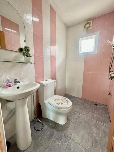 a bathroom with a toilet and a sink at Dream pool villa 2 in Ban Nong Chap Tao