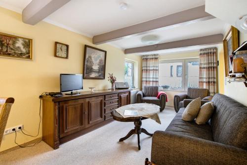 a living room with a couch and a tv at Lachmöwe in Wesselburen