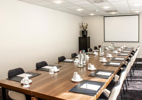 a large conference room with a long table and chairs at Amrâth Grand Hotel Frans Hals in Haarlem