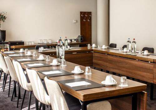 a row of tables and chairs in a restaurant at Amrâth Grand Hotel Frans Hals in Haarlem