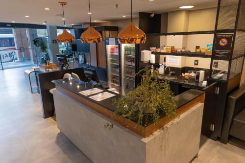 a restaurant with a counter with a counter sidx sidx sidx at Hotel Lieto in Poços de Caldas