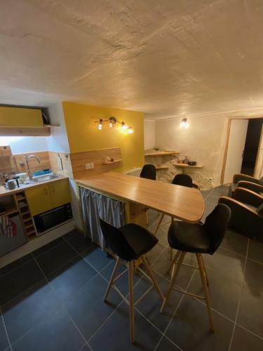 Una cocina con una mesa y sillas de madera en una habitación. en Gîte à la campagne, en Saint-Péray