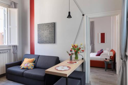 a living room with a couch and a table at Now Apartments, ApartHotel in the heart of Rome in Rome