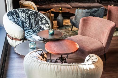a group of chairs and tables in a room at Motel One Berlin Mitte in Berlin