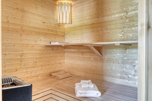 a wooden sauna with two white towels in it at Chalet Monte Bianco I Luxe I Bain nordique I Sauna in Combloux