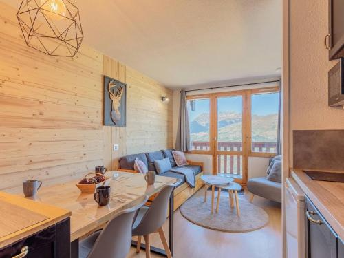 une cuisine et un salon avec une table et des chaises dans l'établissement Appartement cosy 4 pers, balcon Mont Blanc, à 100m des pistes - FR-1-353-108, à La Plagne Tarentaise