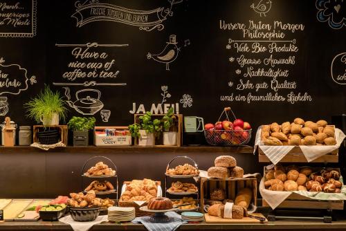 a bakery with different types of bread and pastries at Motel One Hamburg Airport in Hamburg