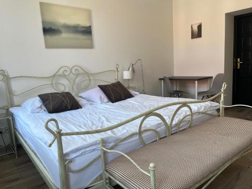 a white bed with two pillows on top of it at Narutowicza 5 Apartments in Inowrocław