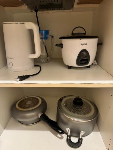a kitchen counter with a blender and a pot and a toaster at Cozy 1BR Netflix & Alexa w Balcony Free Pool in Manila