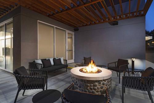 a fire pit on a patio with chairs and a couch at TownePlace Suites by Marriott Brentwood in Brentwood