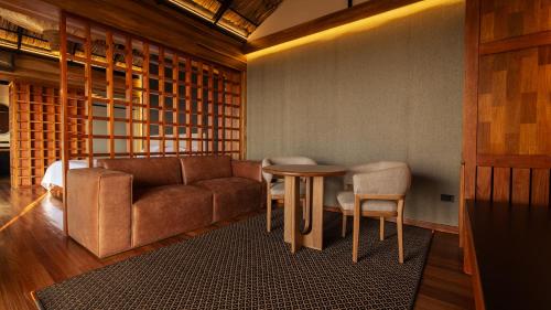 a living room with a couch and a table and chairs at Casa Malva Villas in Buenavista