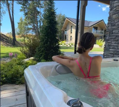 a woman sitting in a bath tub at Mountica Veľká Lomnica in Veľká Lomnica
