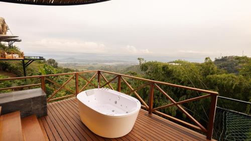 a bath tub sitting on top of a wooden deck at Casa Malva Villas in Buenavista