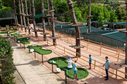 a group of people standing around green miniature golf courses at Villa Norcenni ApartHotel in Figline Valdarno